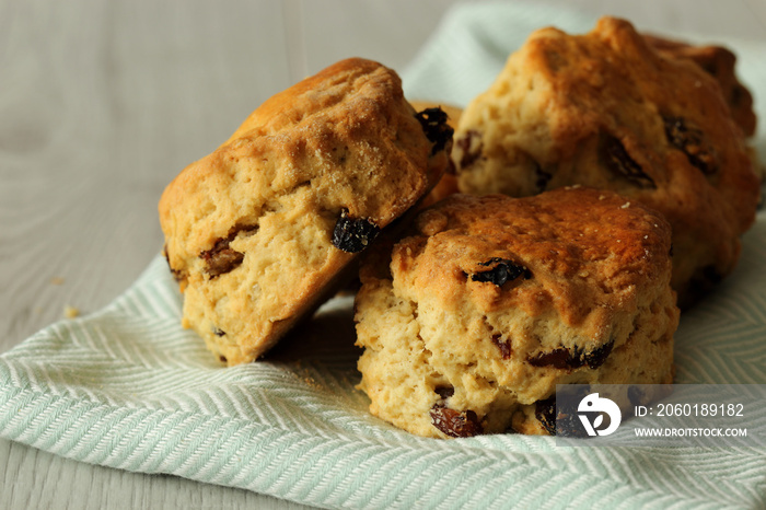 Fruit scones on a pastel green tea towel with a grey wood background