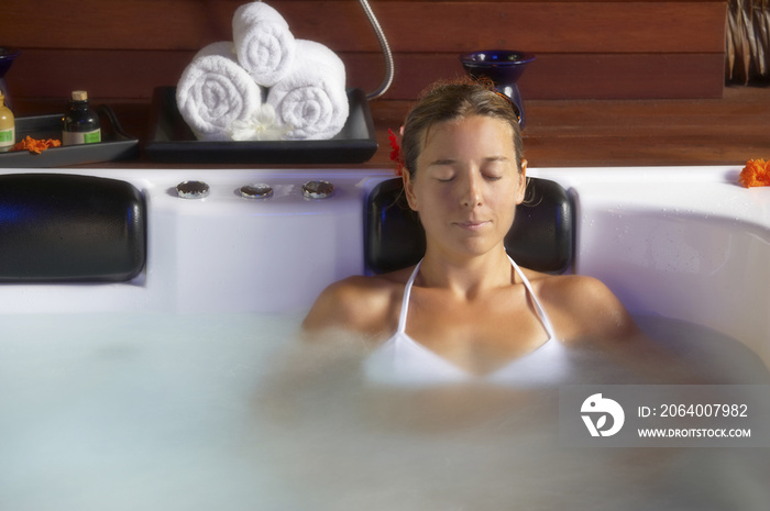 beautiful young woman relaxing in spa