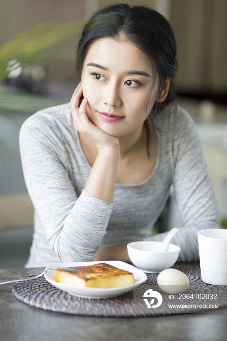 年轻女子在家吃早餐