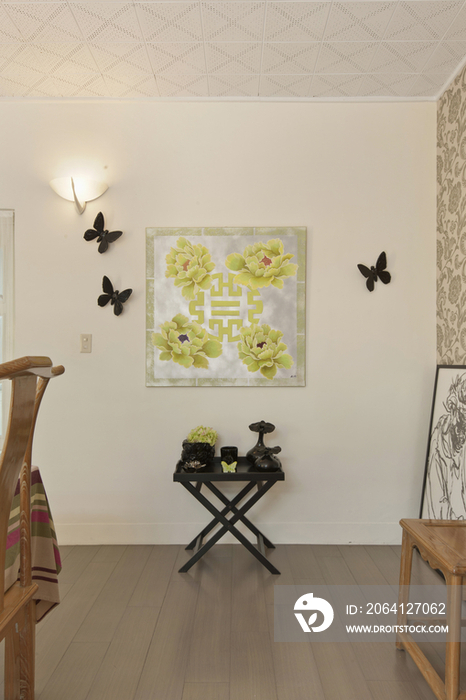 Artifacts on a side table against decorated wall at home