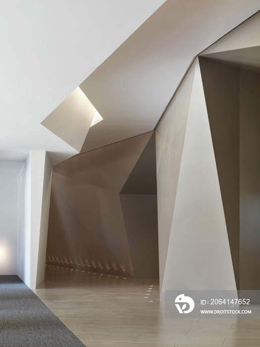 Architectural design and recessed lights along hallway in hotel