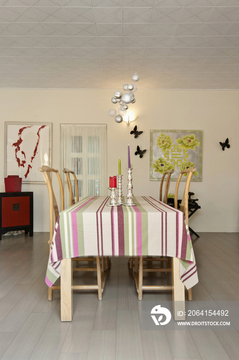 Wooden chairs around dining table in contemporary house