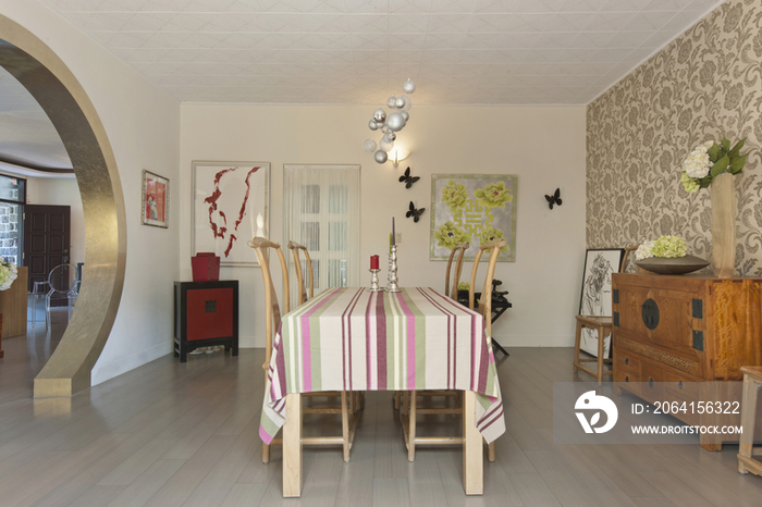 Wooden chairs around dining table in contemporary house