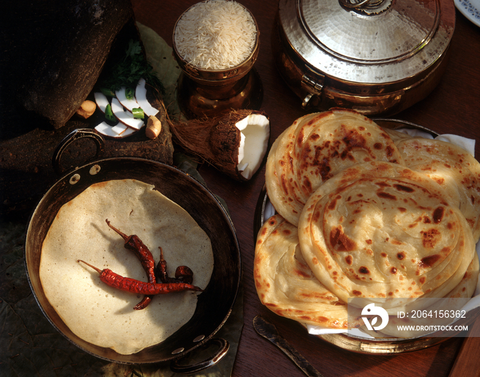 Indian breakfast meals, Appam rice crepes left and Parata right