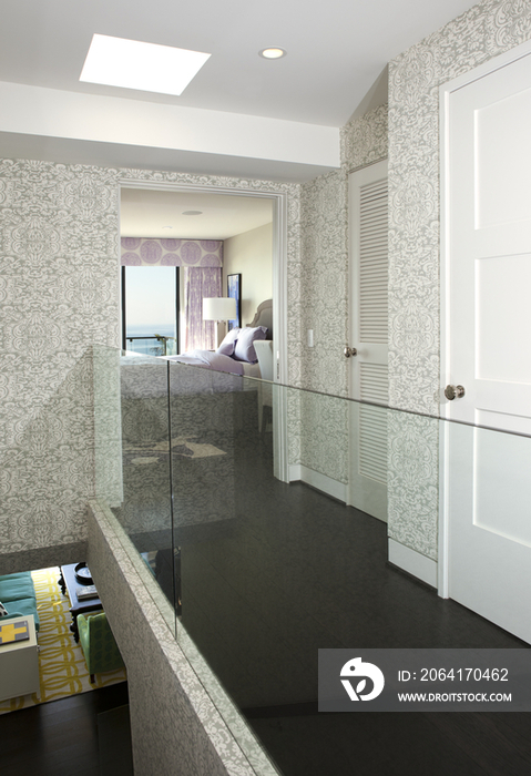 Glass railing along corridor leading toward bedroom; California; United States of America