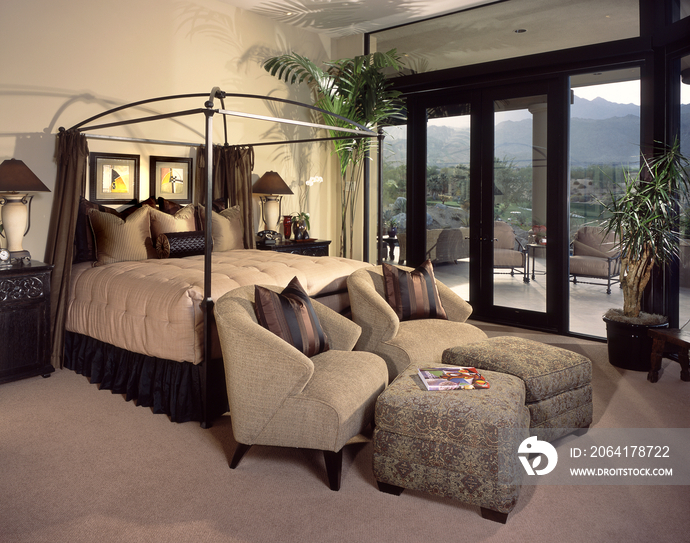 Four-poster bed and seating area in contemporary house