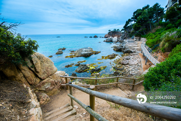 Rocks on the coast of Lloret de Mar in a beautiful summer day,sandy beach, Costa Brava, Catalonia, S