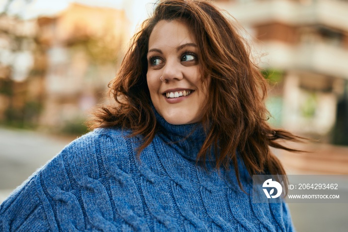 Young irish plus size girl smiling happy standing at the city.