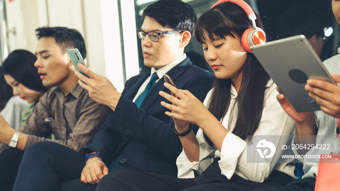 Young people using mobile phone in public underground train . Urban city lifestyle and commuting in 