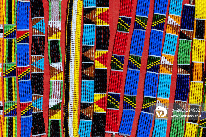 Tribal masai colorful bracelets for sale for tourists at the beach market, close up. Island of Zanzi