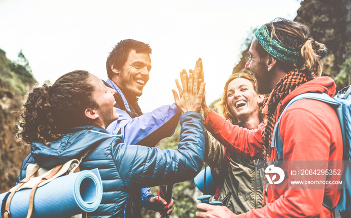 Group of happy trekkers stacking hands outdoor - Focus on hands