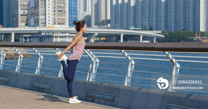 Woman stretch legs before running at outdoor