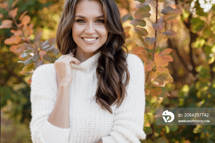 autumn portrait of a happy young woman outdoor