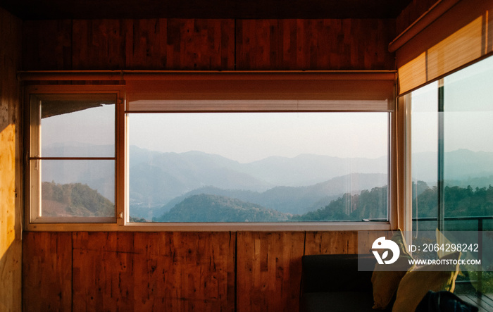 Morning forest and mountain view from wooden cabin living room in Chiang Mai, Thailand