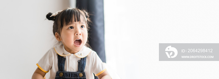 Angry kid.Little asian girl looking at her mother and fighting with her mom.Furious hungry toddler k