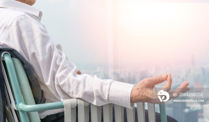 Asia old senior healthy man hand doing easy meditaion for relaxation on rooftop with urban city back