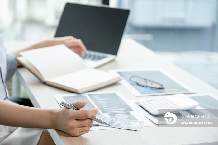 Businesswoman analysis the chart with laptop at the office for setting challenging business goals An