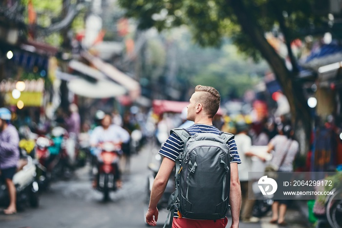 Traveler walking on busy street