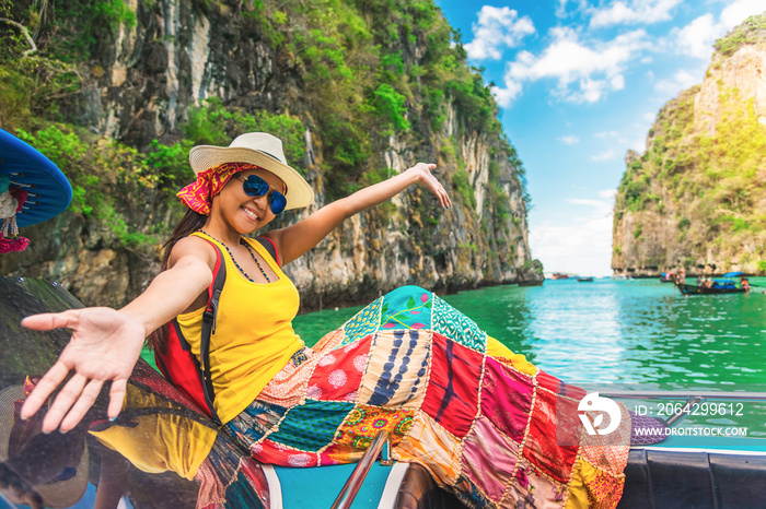 Happy traveler Asian woman in summer dress joy fun relaxing on boat at Pileh lagoon Krabi, Leisure t