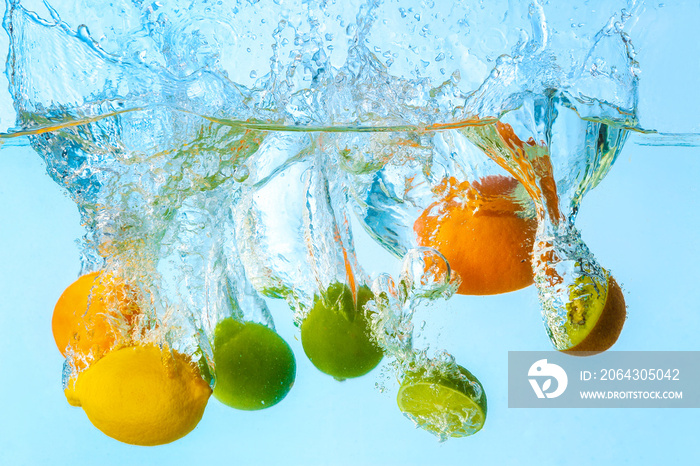 Falling of different fruits into water on light background