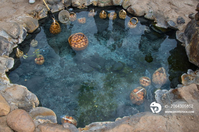 Basket of boiled eggs soak in hot spring (cooked egg yolks and jelly egg), one of popular tourist ac