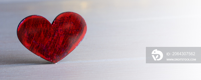 Red heart on  light wooden background for Valentines day celebration or love concept. Large image fo