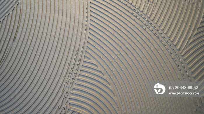 cementitious adhesive applied to the floor ready to receive the ceramic tile