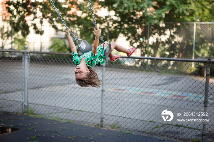 Girl (4-5) using swing