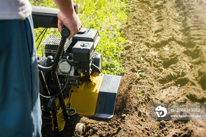 Outdoor garden plow job with a motor cultivator