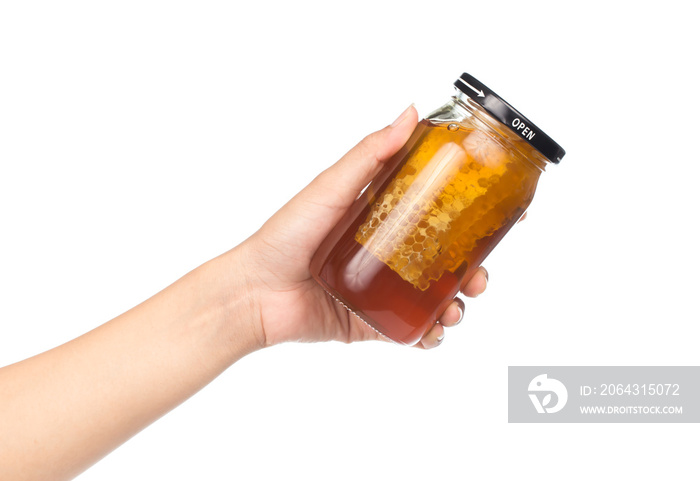 hand holding honey jar isolated on white background