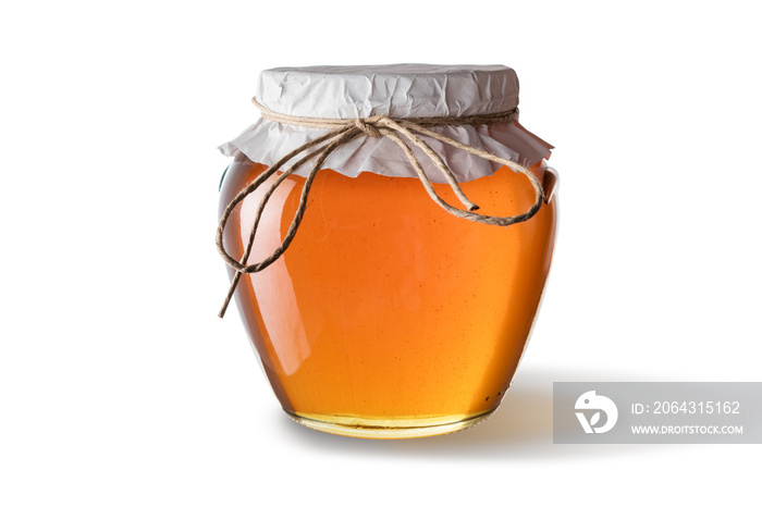 白色背景下分离的罐子里的蜂蜜。