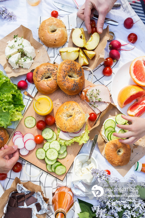 Summer family picnic with bagels, vegetables and fruits.Top view. Healthy lifestyle