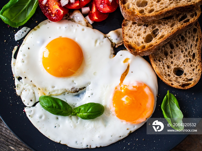 Continental breakfast - sunny side up eggs, toasts and vegetable salad