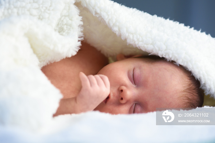 Newborn baby boy portrait on white carpet closeup. Motherhood and new life concept