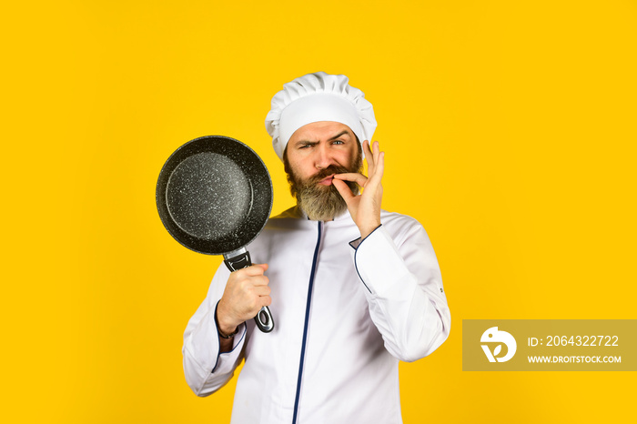 Professional kitchenware. Frying meal. Healthy food. Bearded chef preparing breakfast. Nonstick pan 