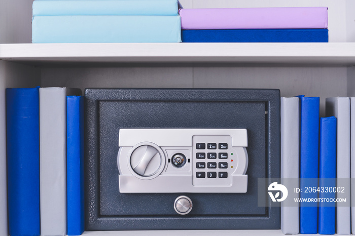 Modern safe on shelf in office