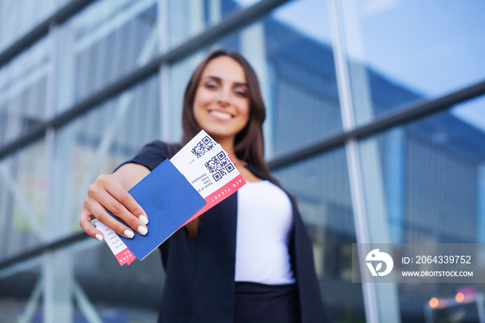 Travel. Woman holding two air ticket in abroad passport near airport