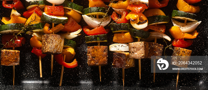 banner of vegan kebabs of vegetables and smoked tofu, in a baking sheet, ready for baking in the ove