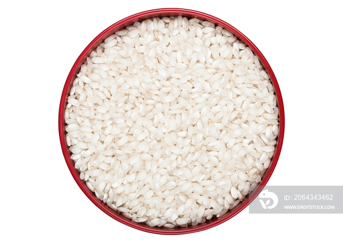 Red bowl of raw organic arborio risotto rice on white background. Healthy food.