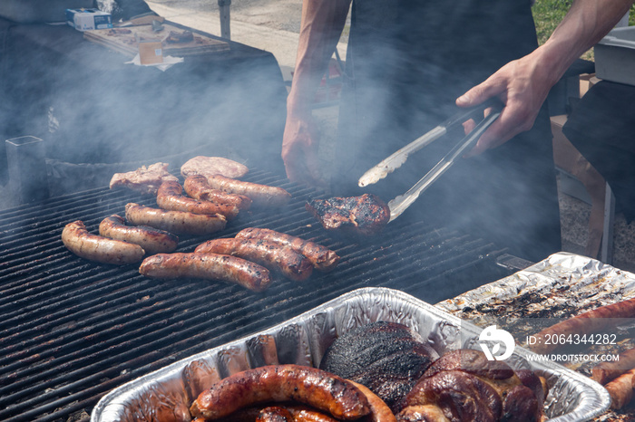 Organic produce sold at farmers market. A closeup view of a hot food vendor cooking pork sausages a