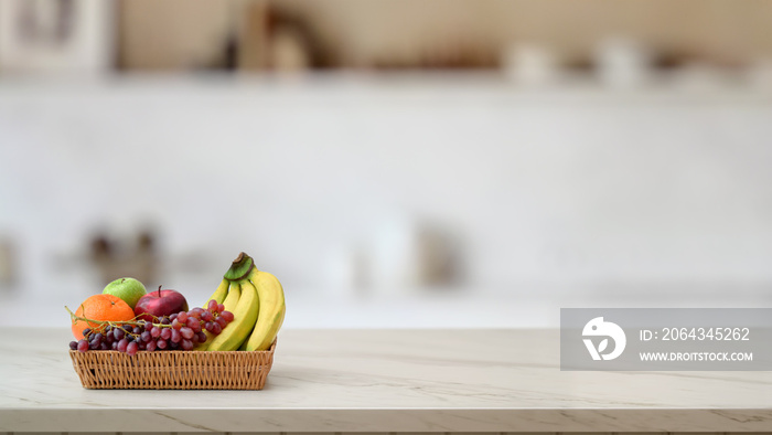 Close up view of fruit basket on marble desk with blurred kitchen room