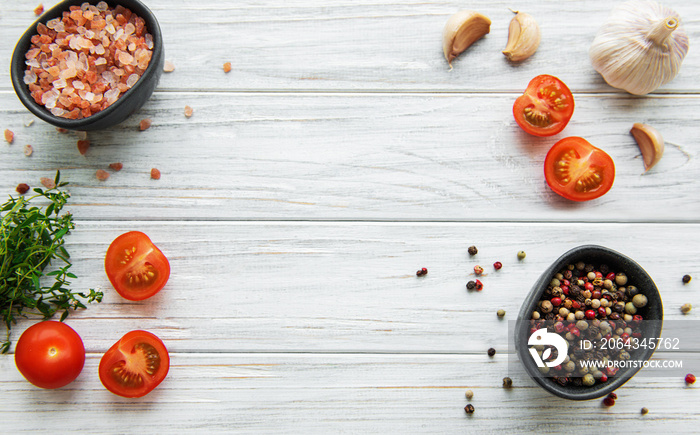 Tomato, basil and pepper with garlic on white wooden background