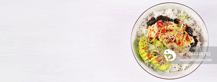 Vegan salad  with rice, pickled kimchi cabbage, avocado,  nori and sesame on bowl. Sushi-food hybrid