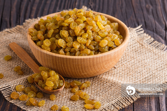 golden raisins on a wooden rustic background