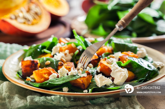 Roasted pumpkin salad with spinach and nuts