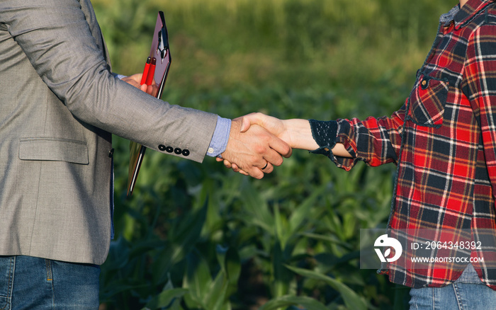 Farmer and businessman shaking hands