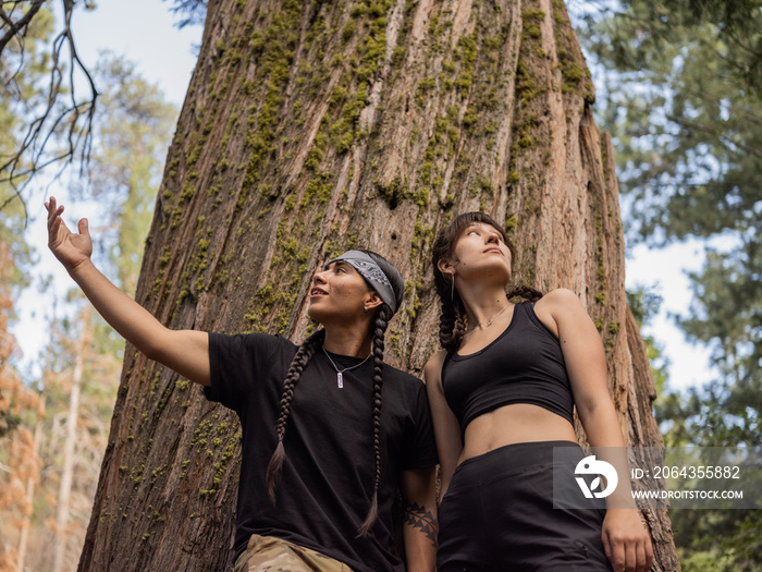 Indigenous man and woman under a tree