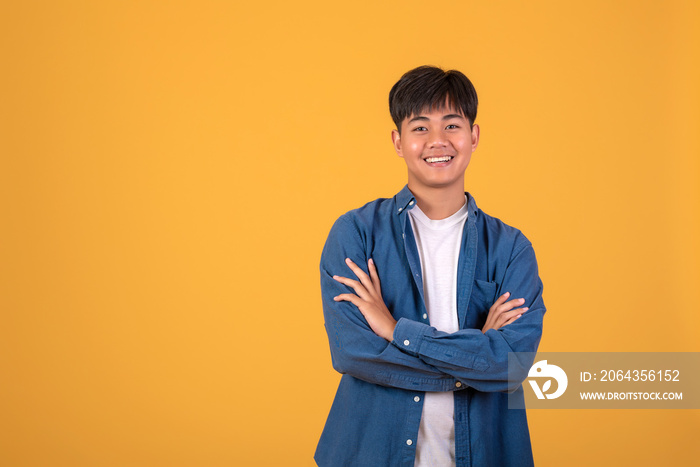 On orange background With a young Asian man Happy standing.