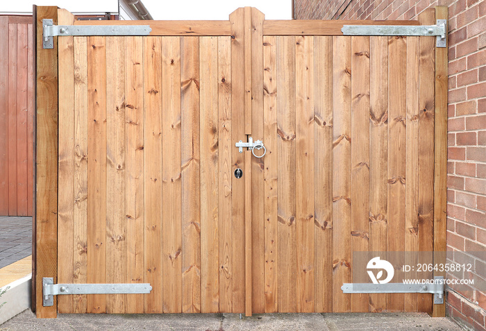 Double wooden gates with metal latch and hinges