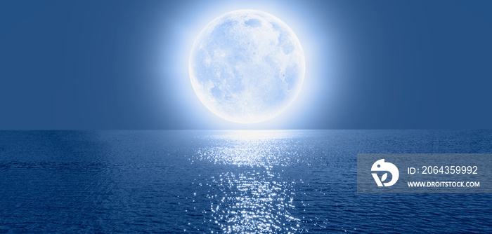 Full moon rising over empty ocean at night, calm sea wave in the foreground Elements of this image f